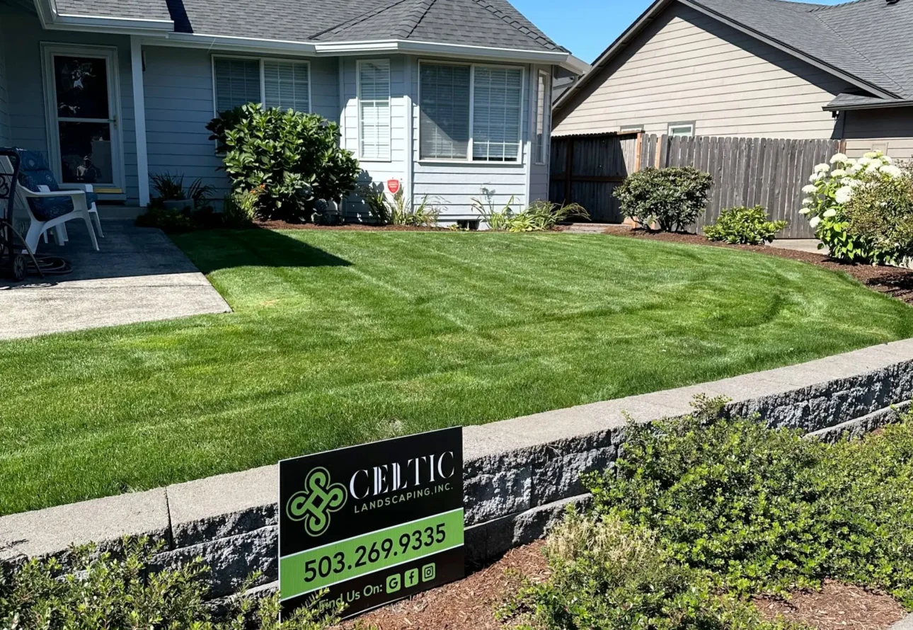 Celtic Landscaping front yard lawn maintenance with newly mowed grass and tidy garden beds